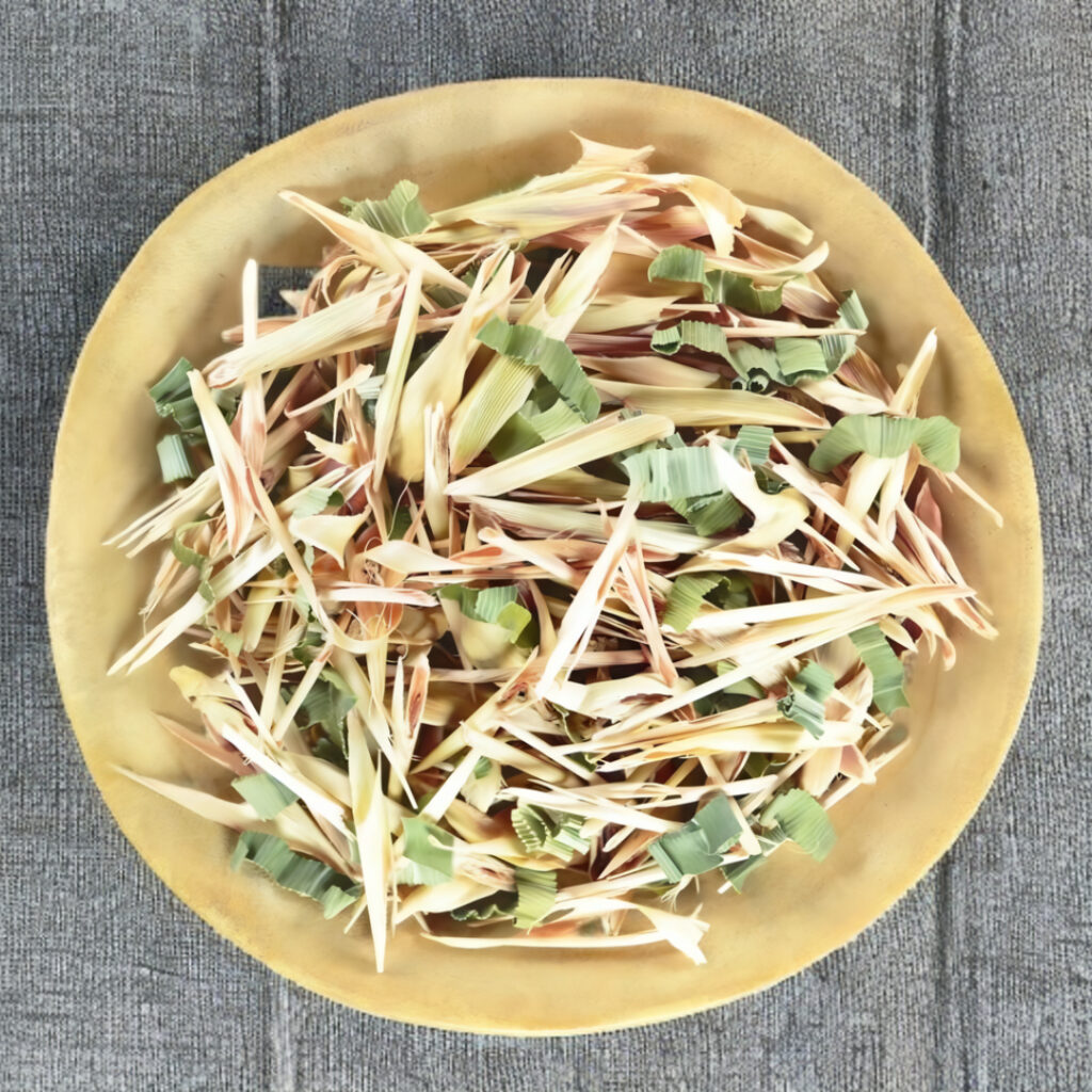 Dried lemongrass and pandan pieces in a wooden bowl