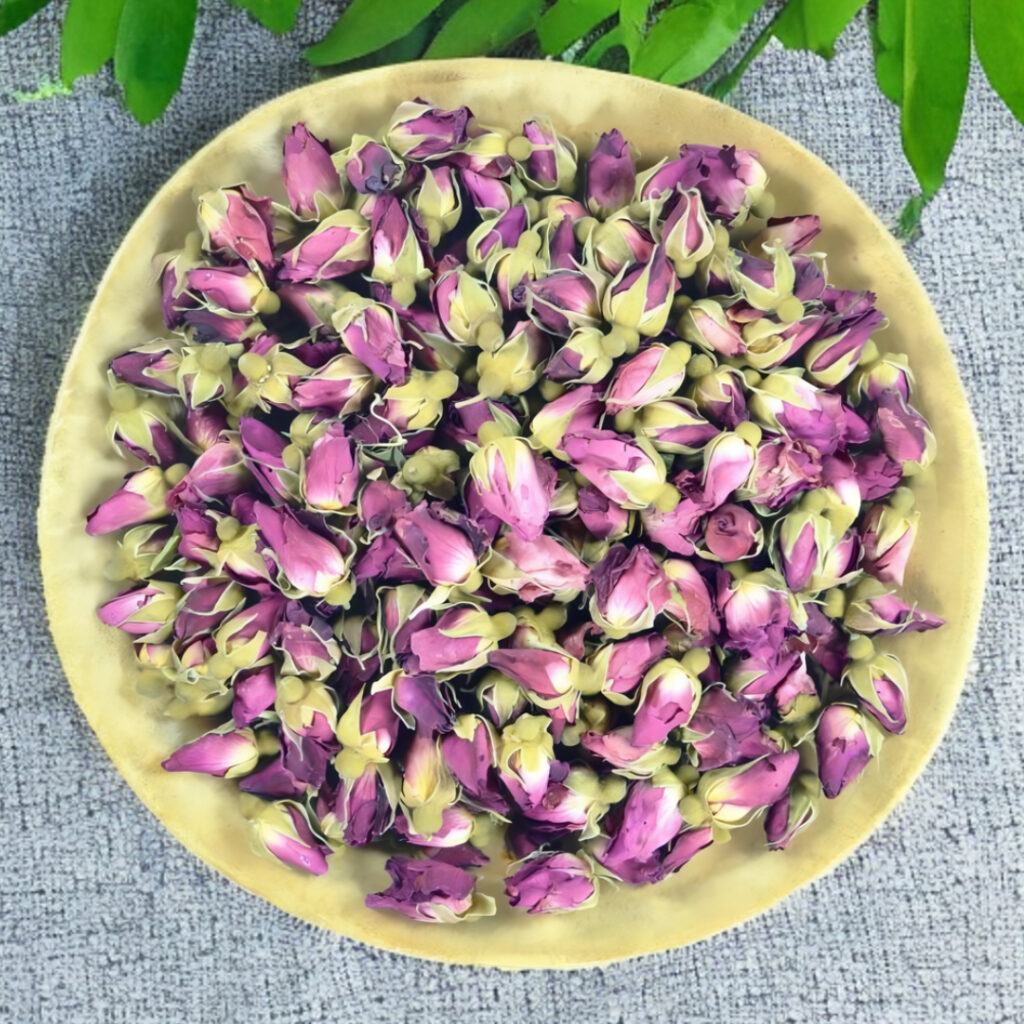 Dried pink rose buds in a wooden bowl