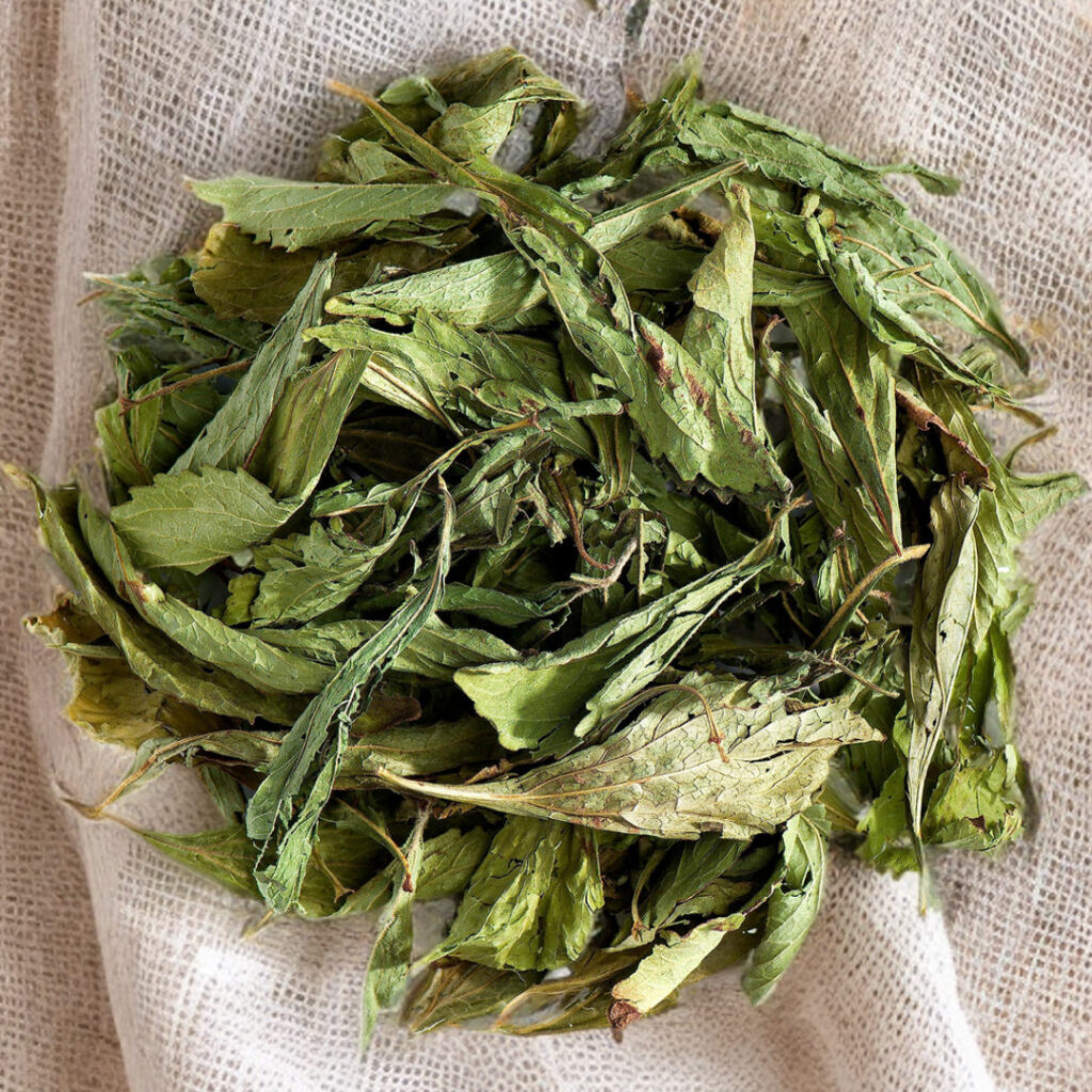 Dried stevia leaves on a linen cloth